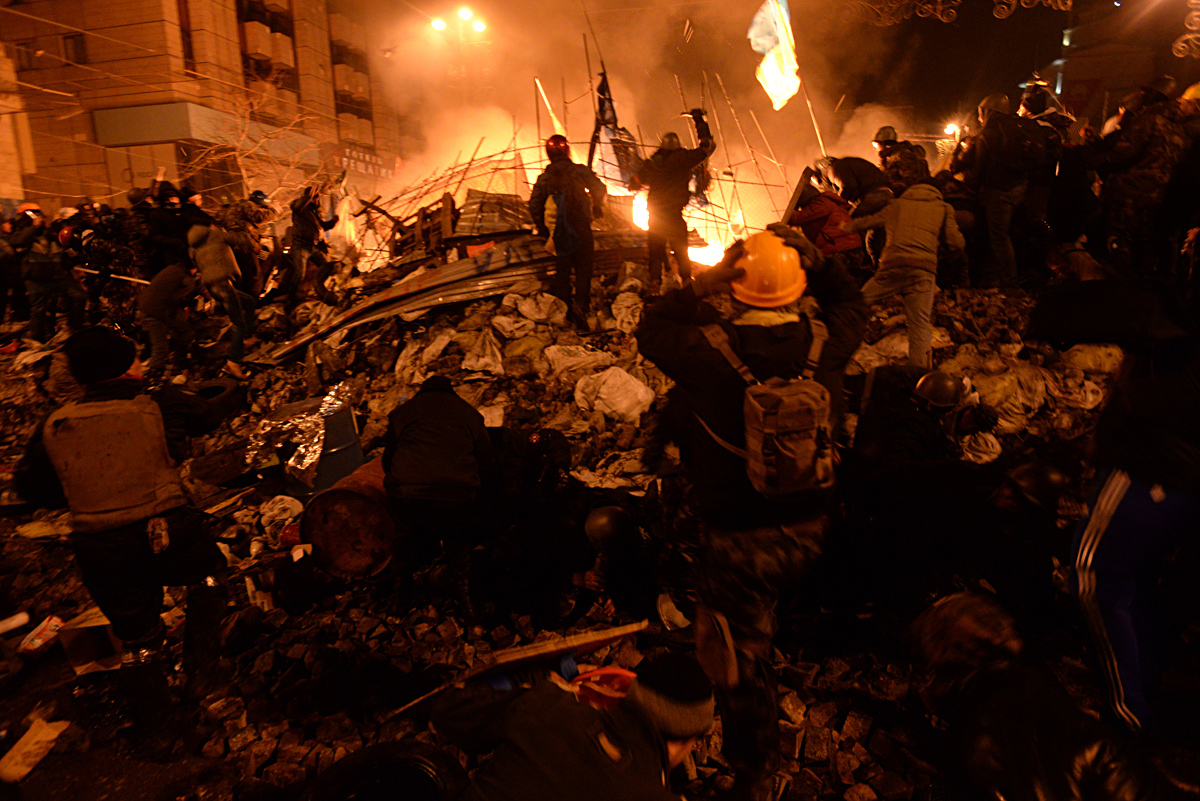 A major aim of prepping is to avoid becoming a refugee in a collapsed economy/government. Protesters fighting government forces during the  Ukrainian revolution of 2014.