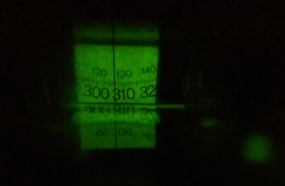 Looking through the lensatic sighting system of the Silva Expedition 54 Compass at night.